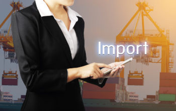 Businesswoman holding phone over container cargo freight ship with working crane bridge in shipyard background, Business industry logistic import export concept.