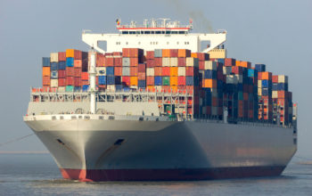 ANTWERP, BELGIUM - MAR 12, 2016: Container ship OOCL Singapore leaving a container terminal in the Port of Antwerp.